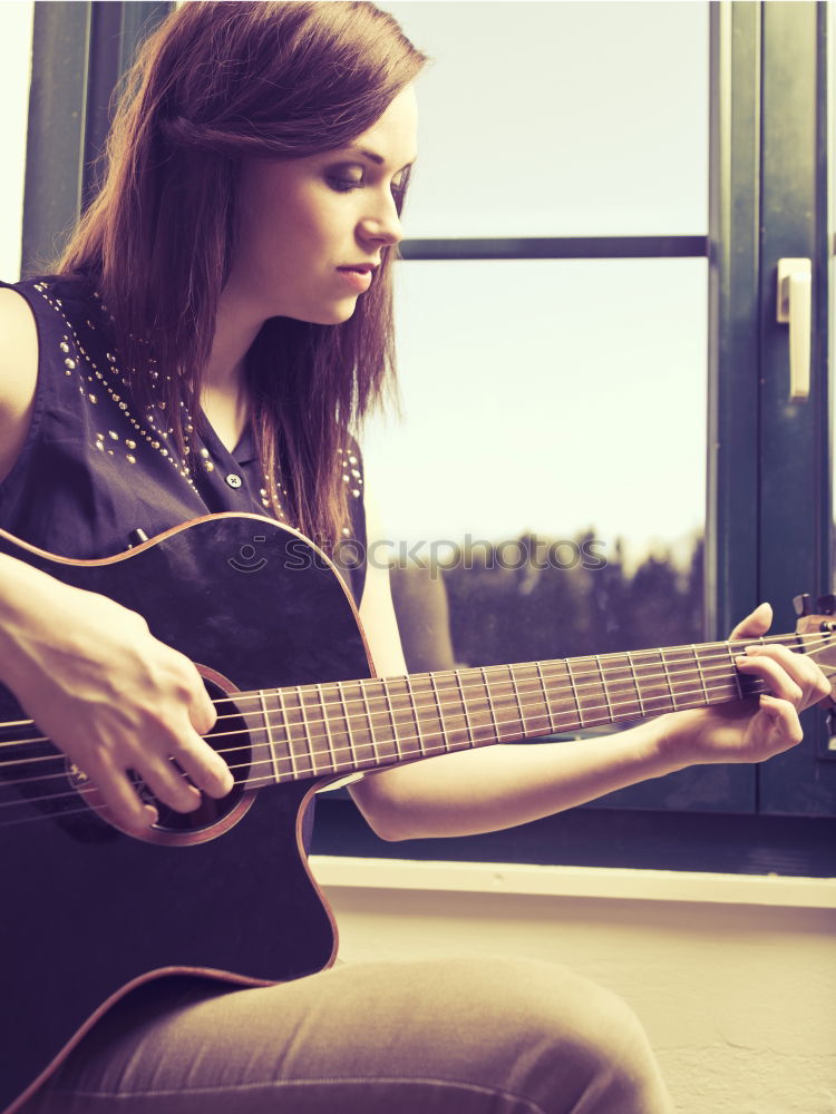 Similar – Beautiful woman playing guitar.