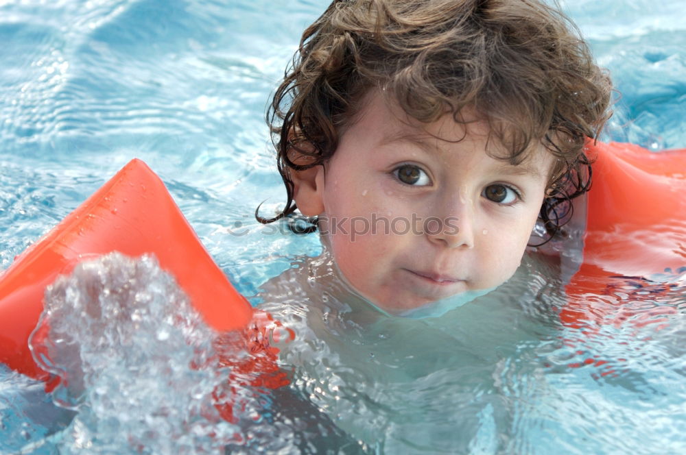 Similar – Image, Stock Photo Young boy in inflatable tube swimming with a big smile on his face