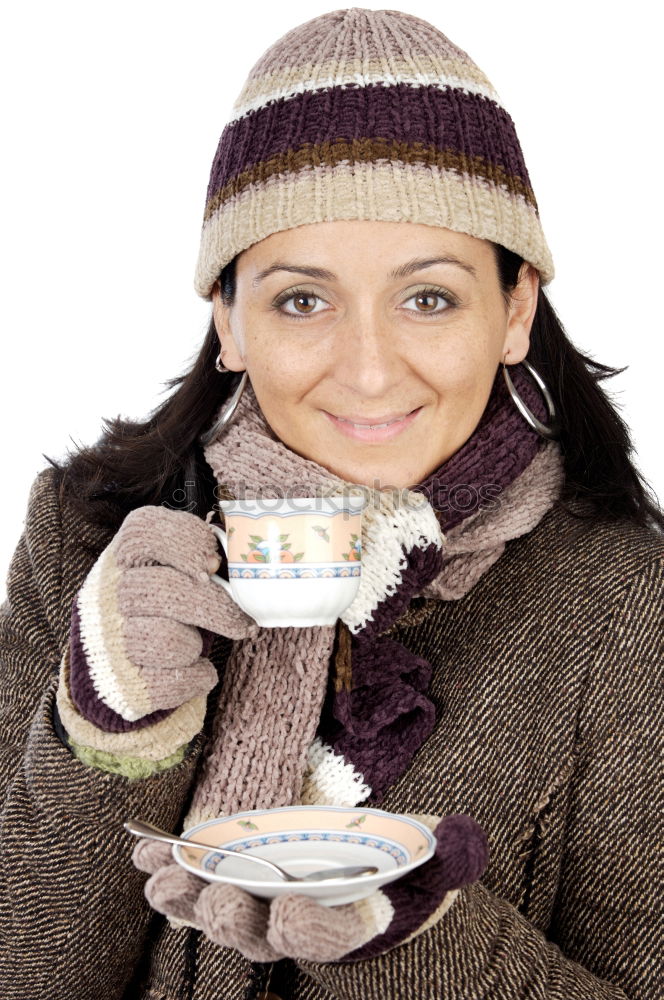 Young woman holding warm cup of tea