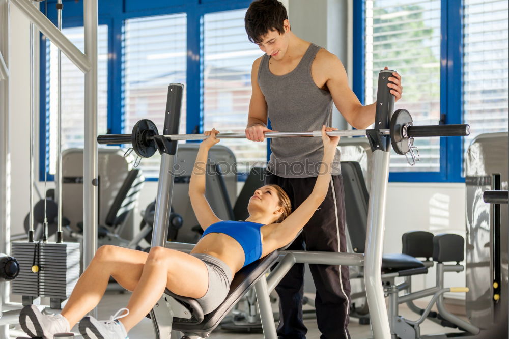 Similar – Image, Stock Photo Female personal trainer helping a young man lift weights