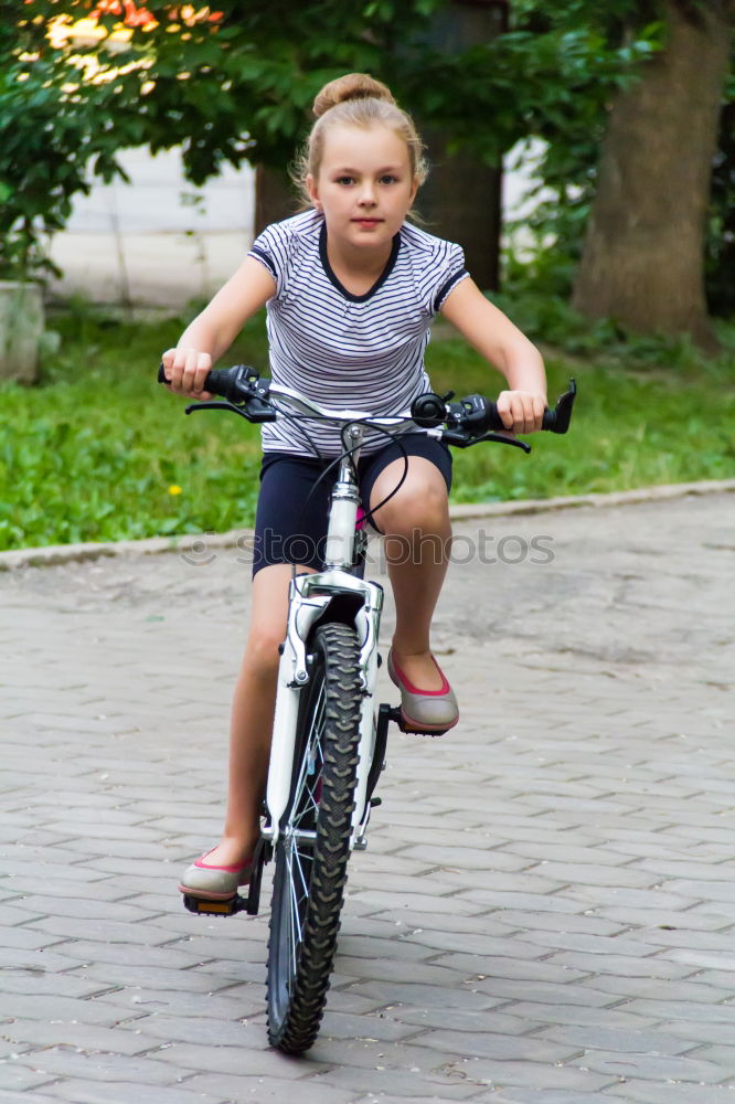 Similar – Cute girl driving bicycle in summer