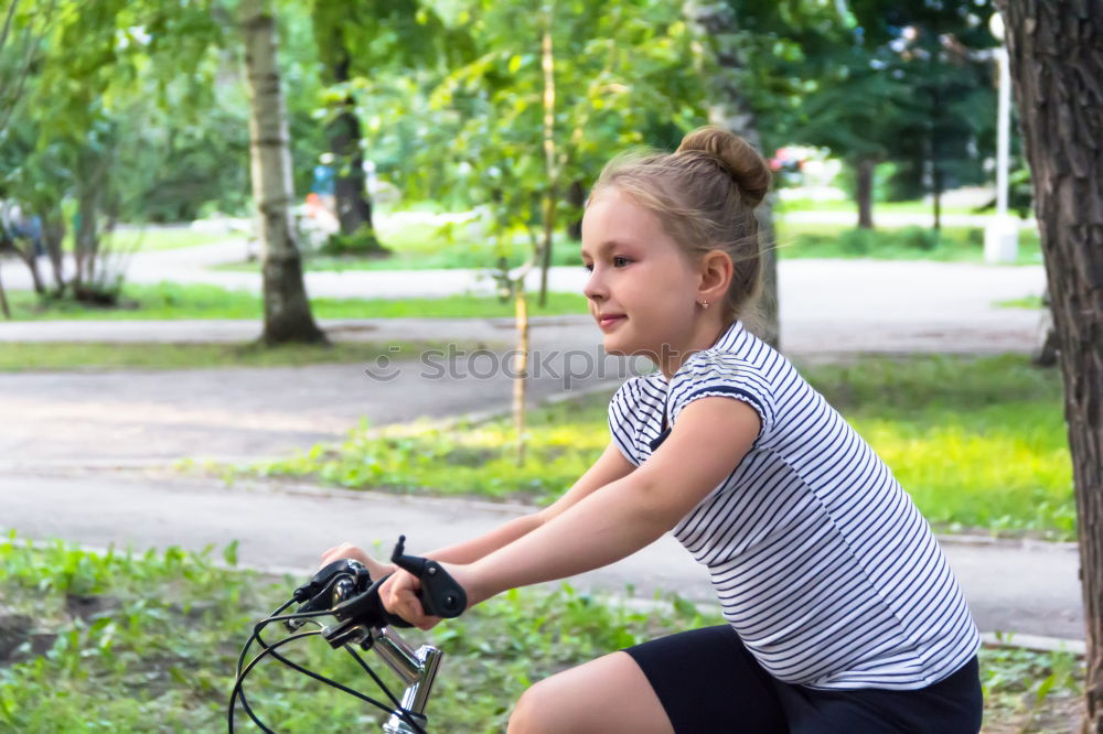 Similar – Cute girl driving bicycle in summer