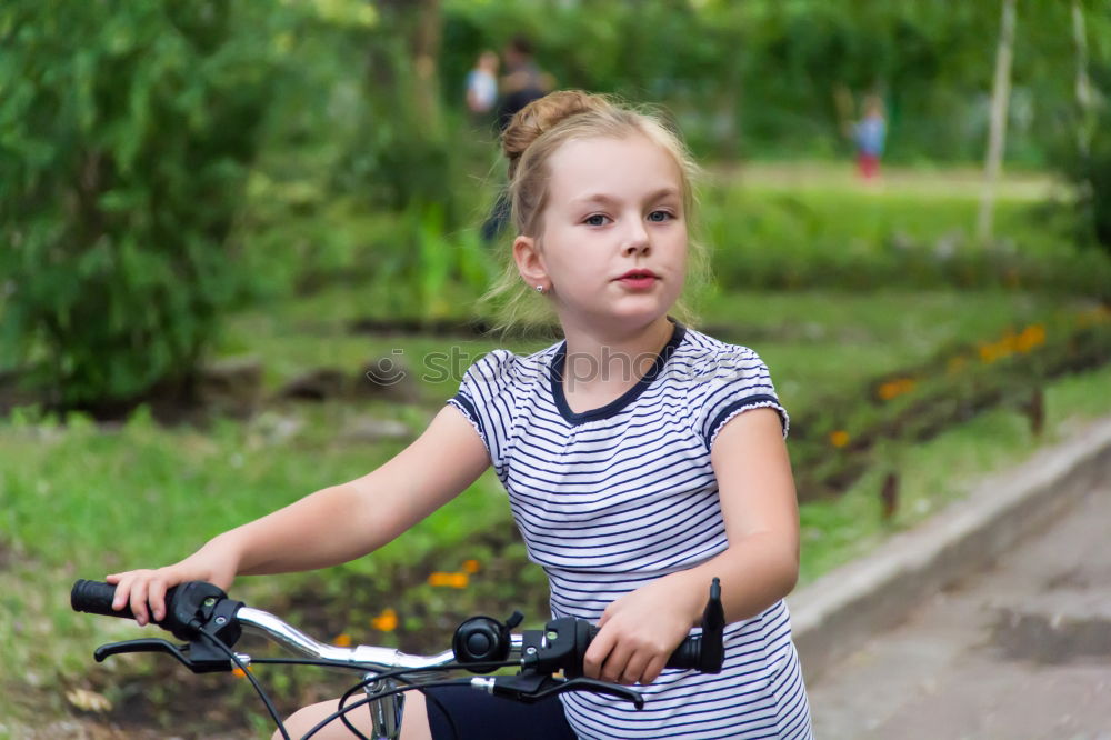 Similar – Cute girl driving bicycle in summer