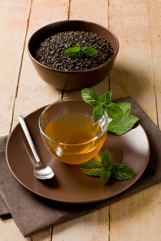 Similar – Black tea with jasmine in a white cup on a brown wooden table