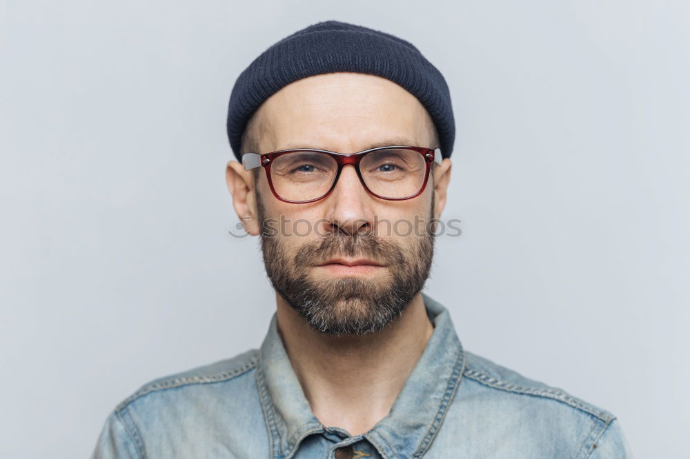 Similar – Man with mustache and glasses standing with crossed arms.