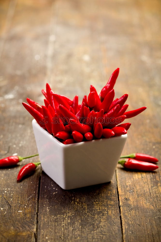 Similar – Image, Stock Photo Red hot chili peppers on a wooden background