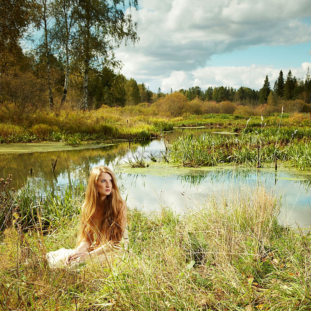 Similar – Image, Stock Photo analog medium format portrait of young woman in summer dress sitting barefoot among bushes in nature on a lakeside