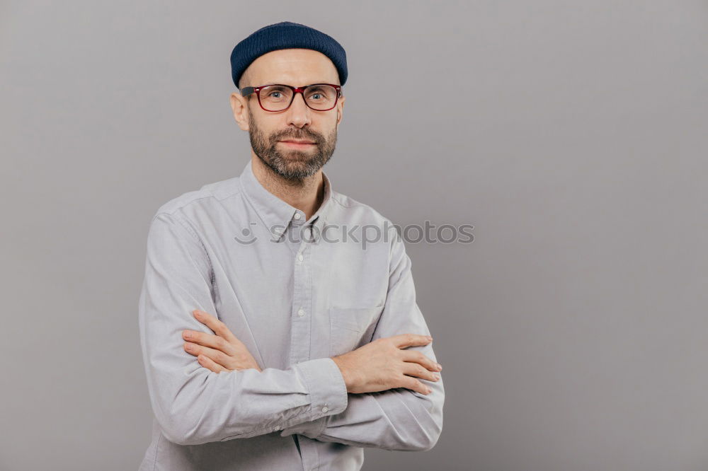 Similar – Man with mustache and glasses standing with crossed arms.