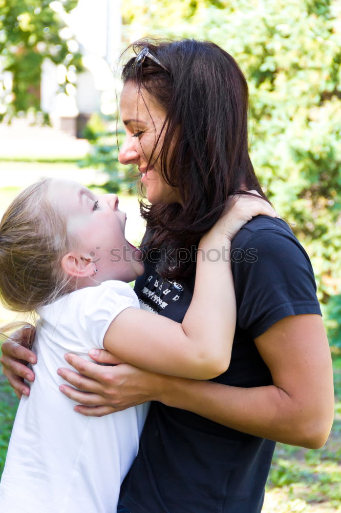 Kissing mother and daughter in summer