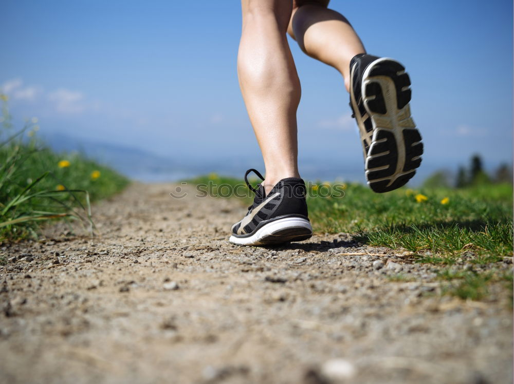 Similar – Image, Stock Photo Close-up shot of man tying running shoes with foot on the bench. Getting ready before jogging. Going in for sports, healthy lifestyle