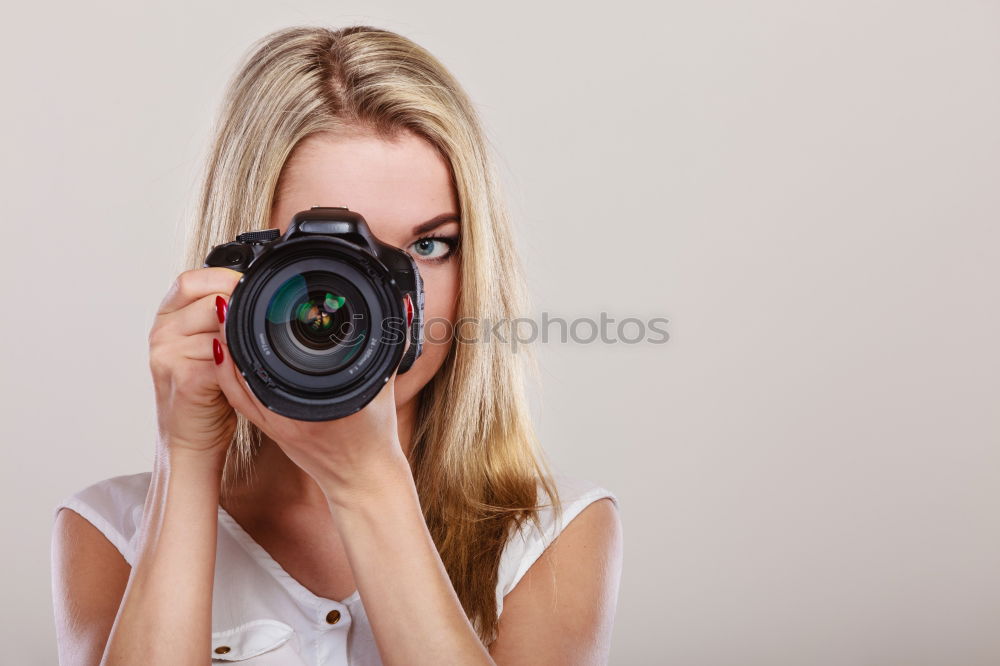 Similar – close up portrait of a young woman holding a camera. Photography concept