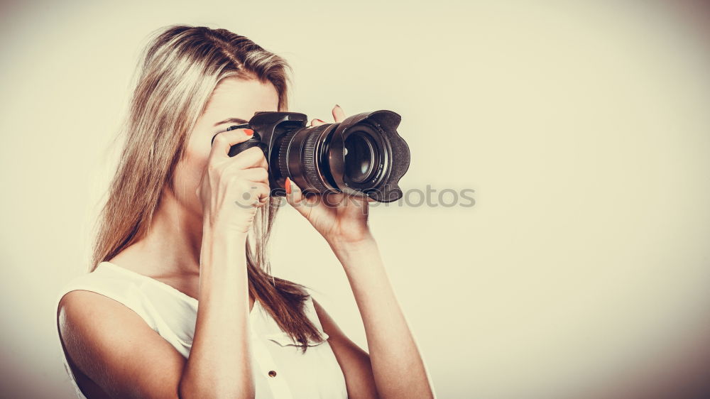 Similar – Close up of a photographer with her camera.