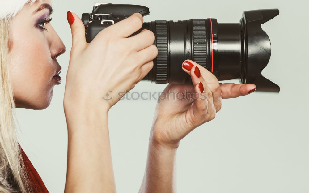 Similar – close up portrait of a young woman holding a camera. Photography concept