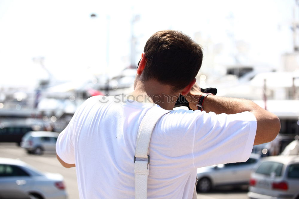 Similar – Man with tattoos holding skateboard at shore. Back view.