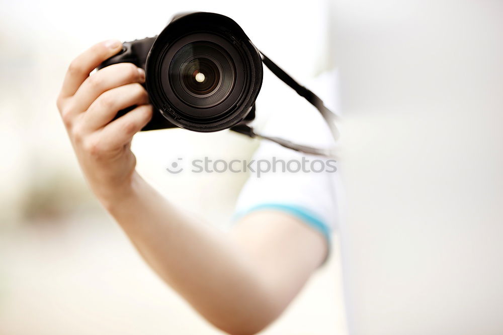 Similar – Close up of a photographer with her camera.