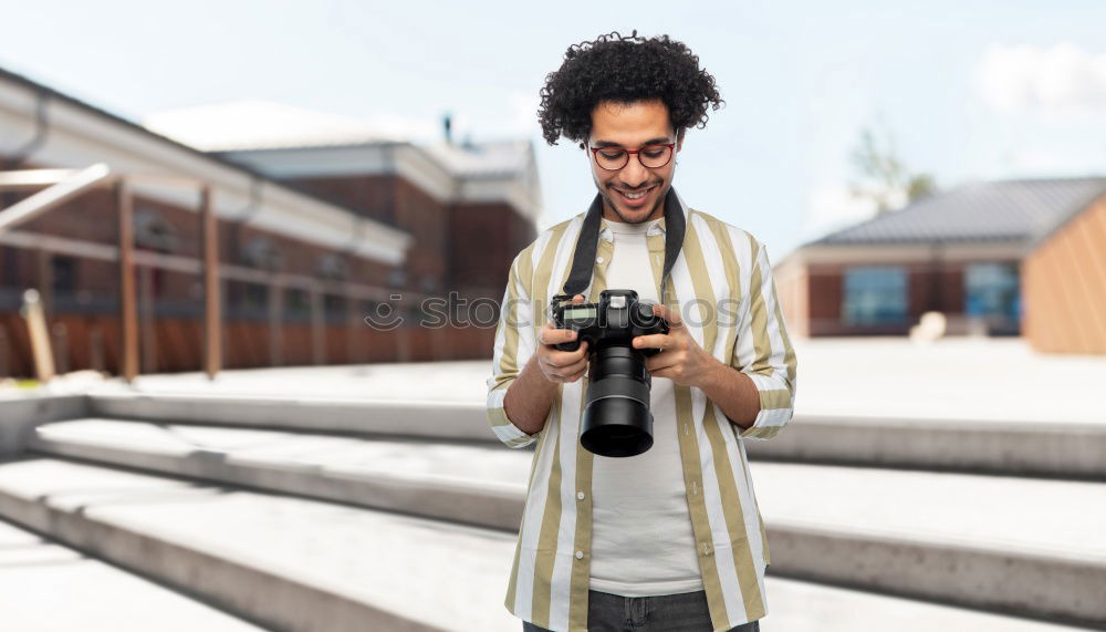 Similar – Young modern man sitting on halfpipe taking picture with Camera