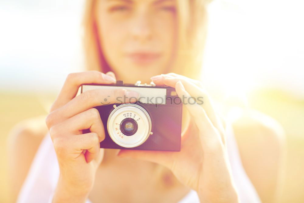 Similar – Close up of a photographer with her camera.