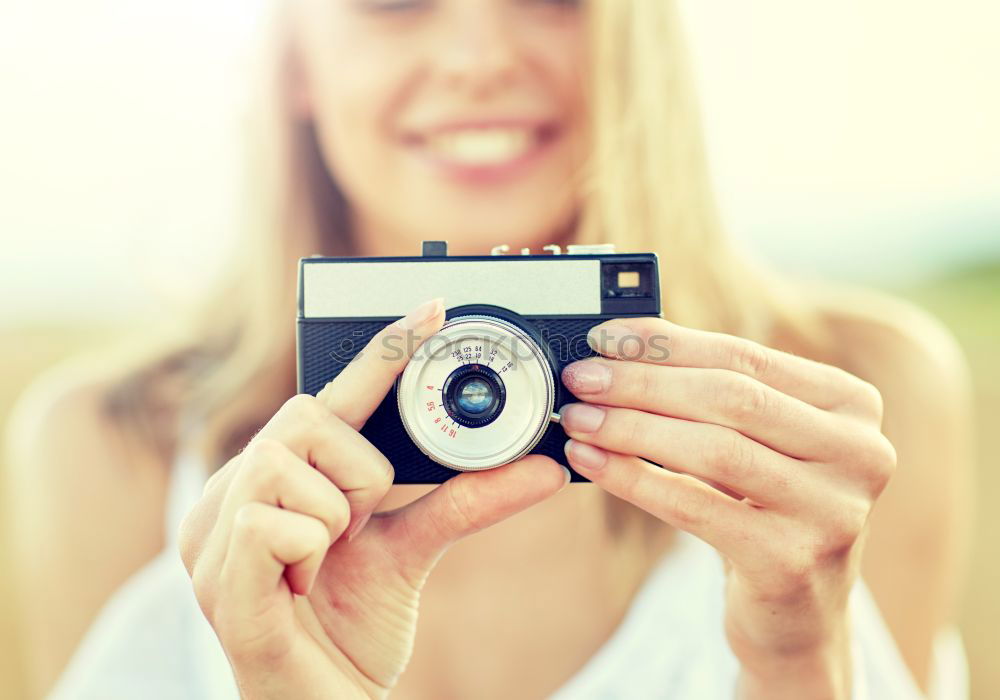 Similar – Close up of a photographer with her camera.