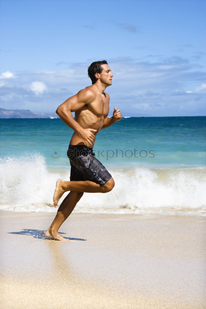 Similar – Man running at sunset on a sandy beach in a sunny day