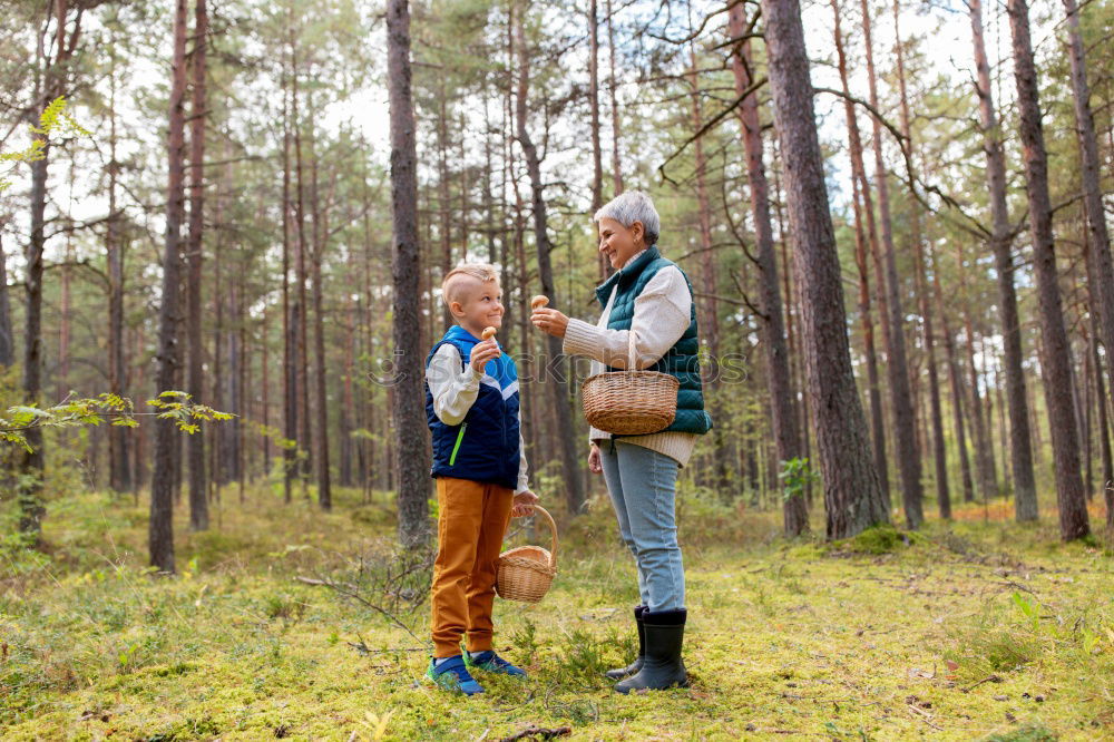 Elferly fit happy couple hiking through forest together on vacation