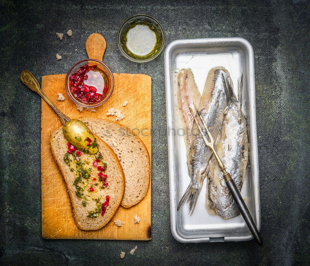 Pickled herrings with slices of bread and onion sauce