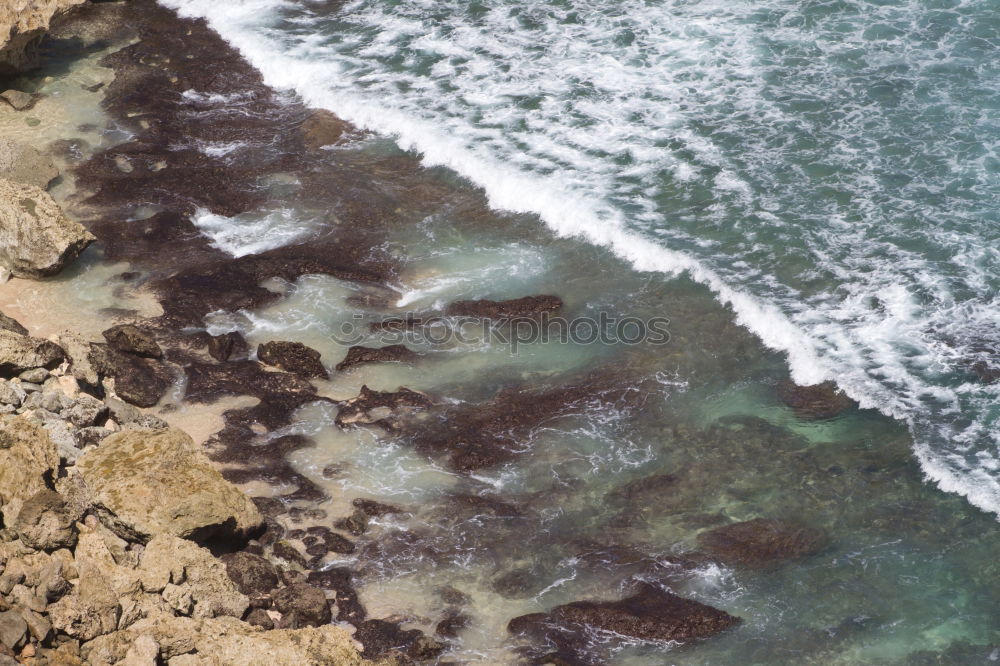 Similar – Aerial views of a coastline with waves and rocks