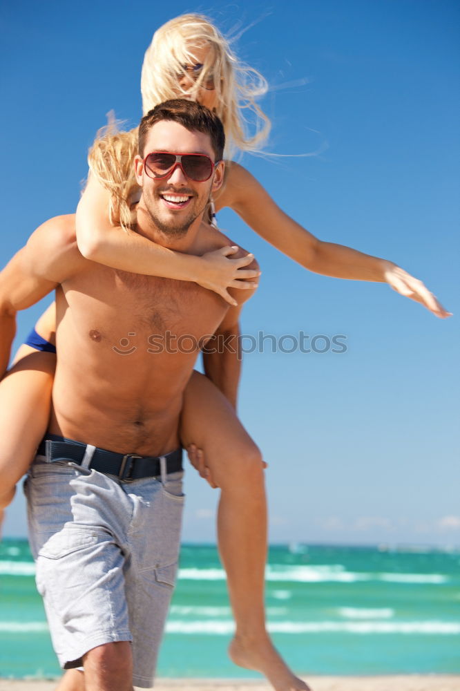 Similar – Happy young family of three at the beach