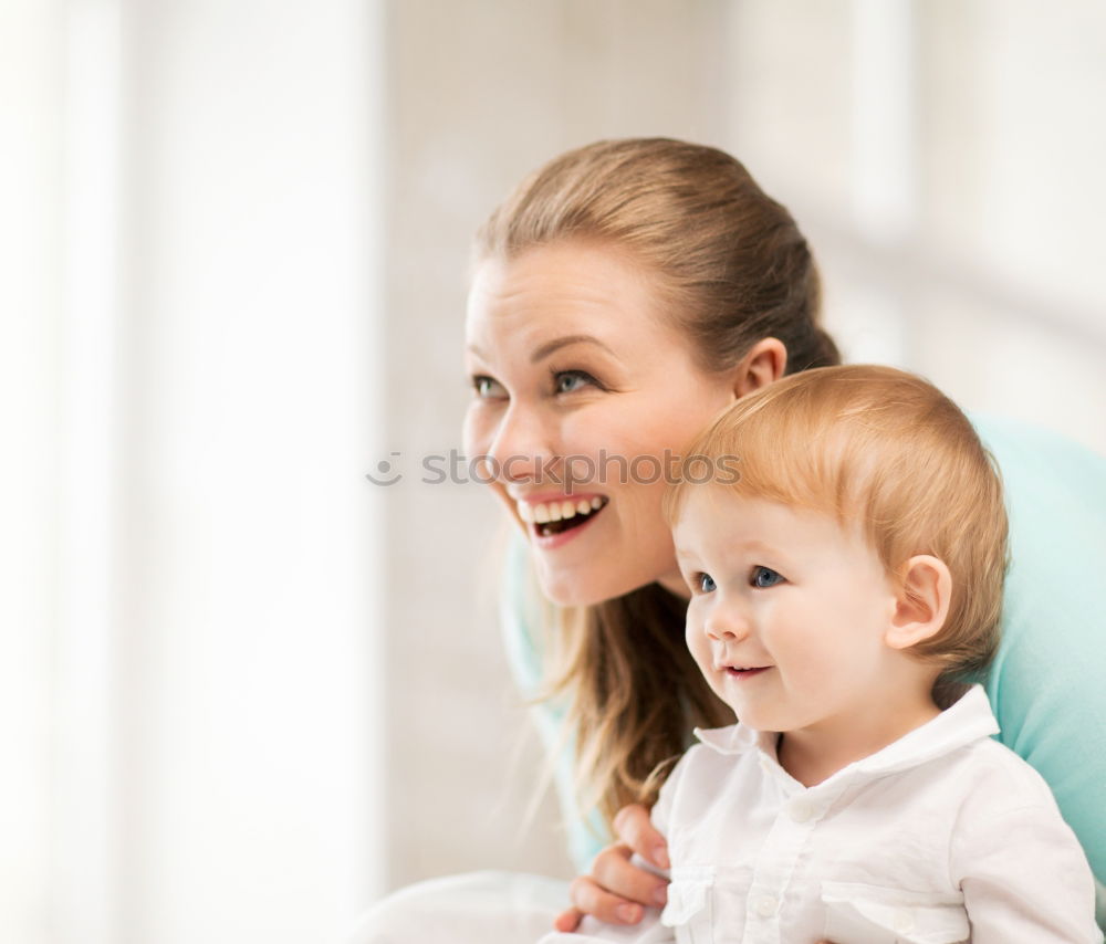 Similar – happy young mother and her baby boy lying on bed and smiling