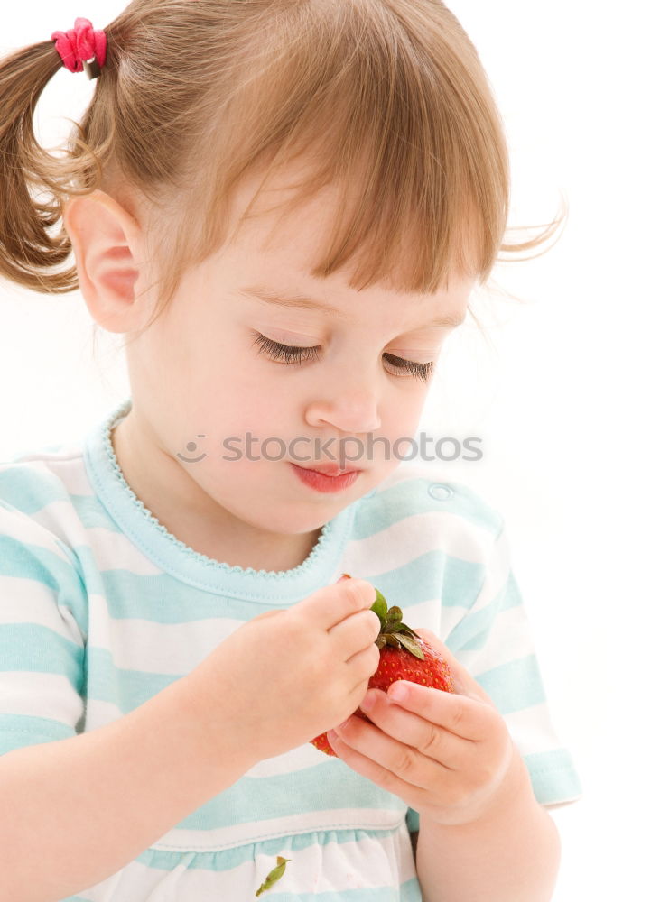 Similar – Child nibbles raspberries from his fingers