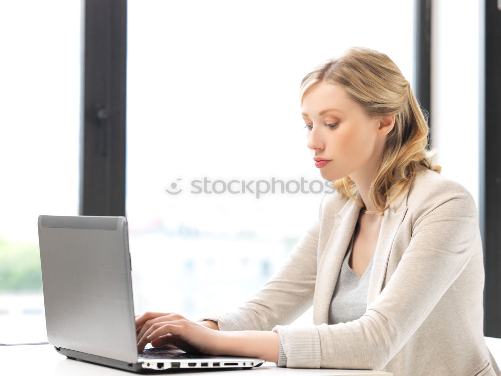 Similar – Concentrated young lady using laptop and sitting at table