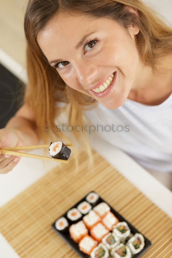 Similar – Crop woman eating sushi