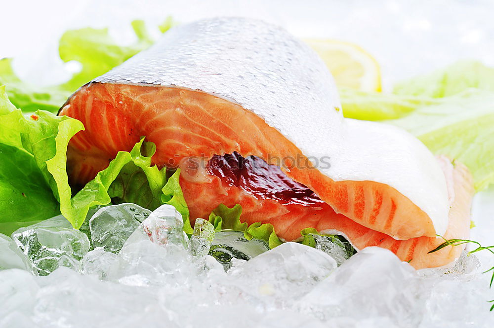 Similar – Raw salmon fillet with green herbs and lemon