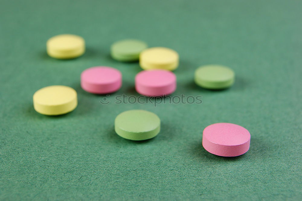 Similar – white plastic can and scattered oval pills