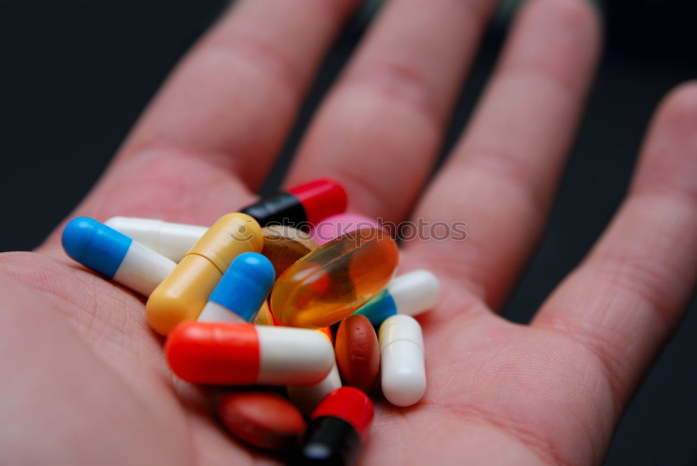 Similar – Hand and various pills on it. Human skin and medicines.