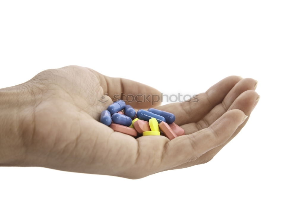 Similar – A hand in which several different colored tablets are lying; addiction problems, drug abuse, suicide