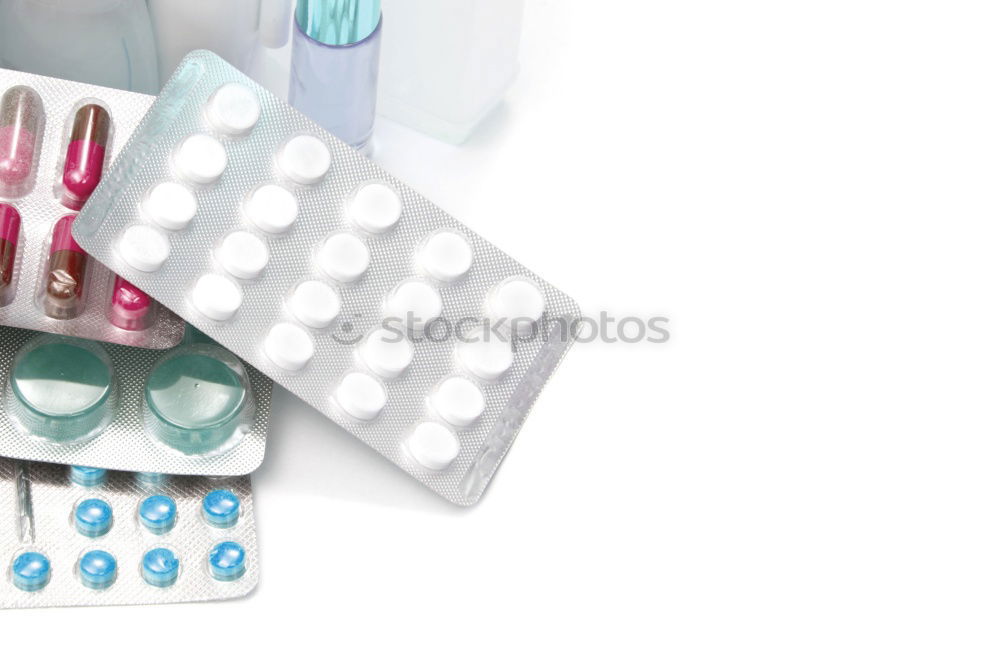 Similar – pill bottle,blister with white tablets,painkillers and a glass of water.Concept of medicine