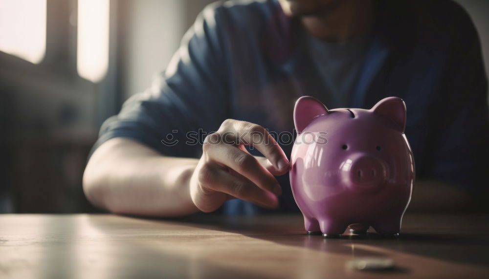 Similar – Unhappy man angry at his piggy bank