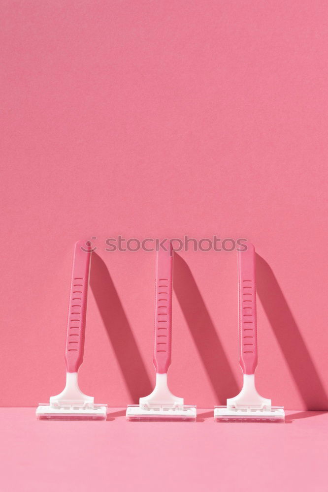 Paper scroll with ribbon on pink background