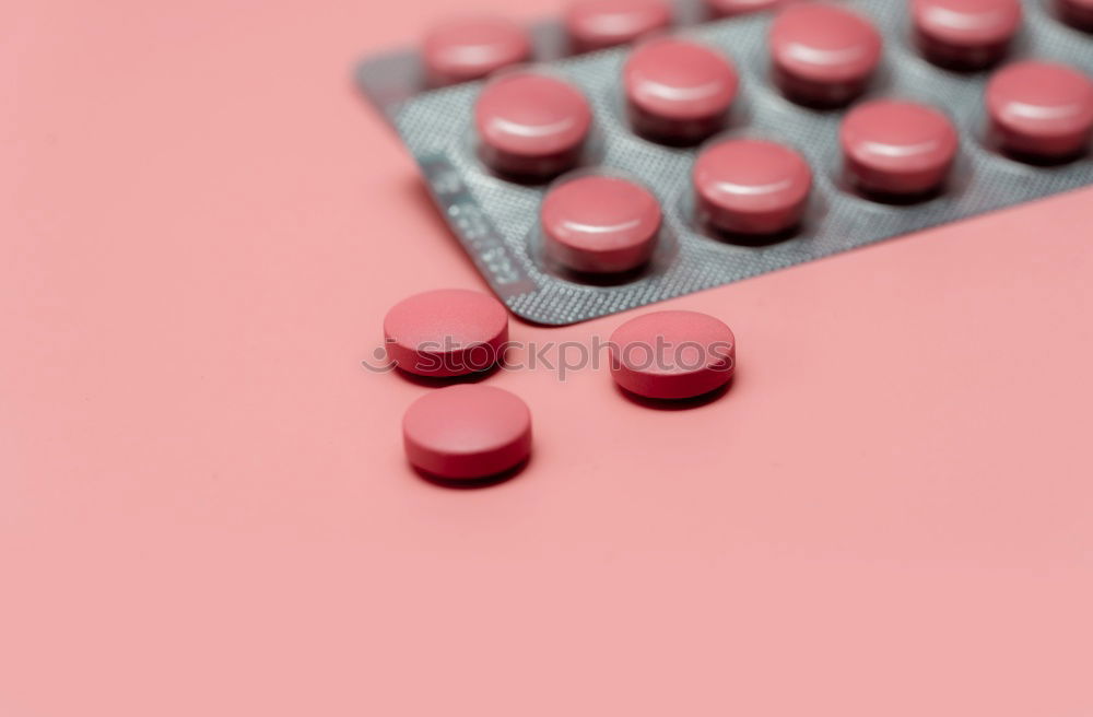 Similar – Pink round tablets pills in blister pack on pink background. Painkiller medicine. Take pill. Pharmacy product package. Pharmaceutical industry. Prescription drugs. Tablets pills for relieve pain.