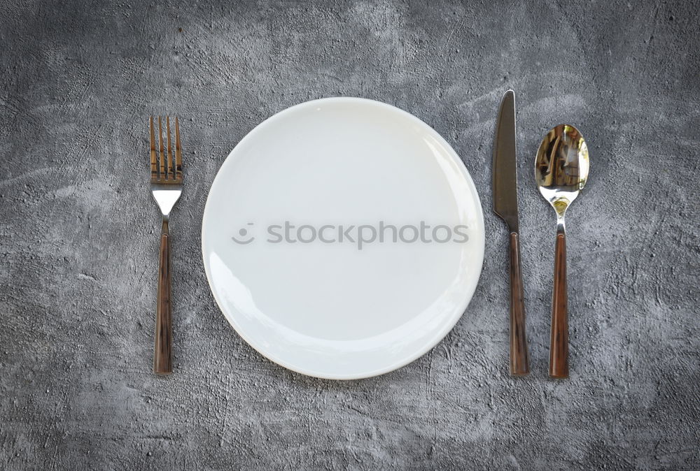 Similar – Fish is healthy: a small fish on a large plate with knife and fork and napkin