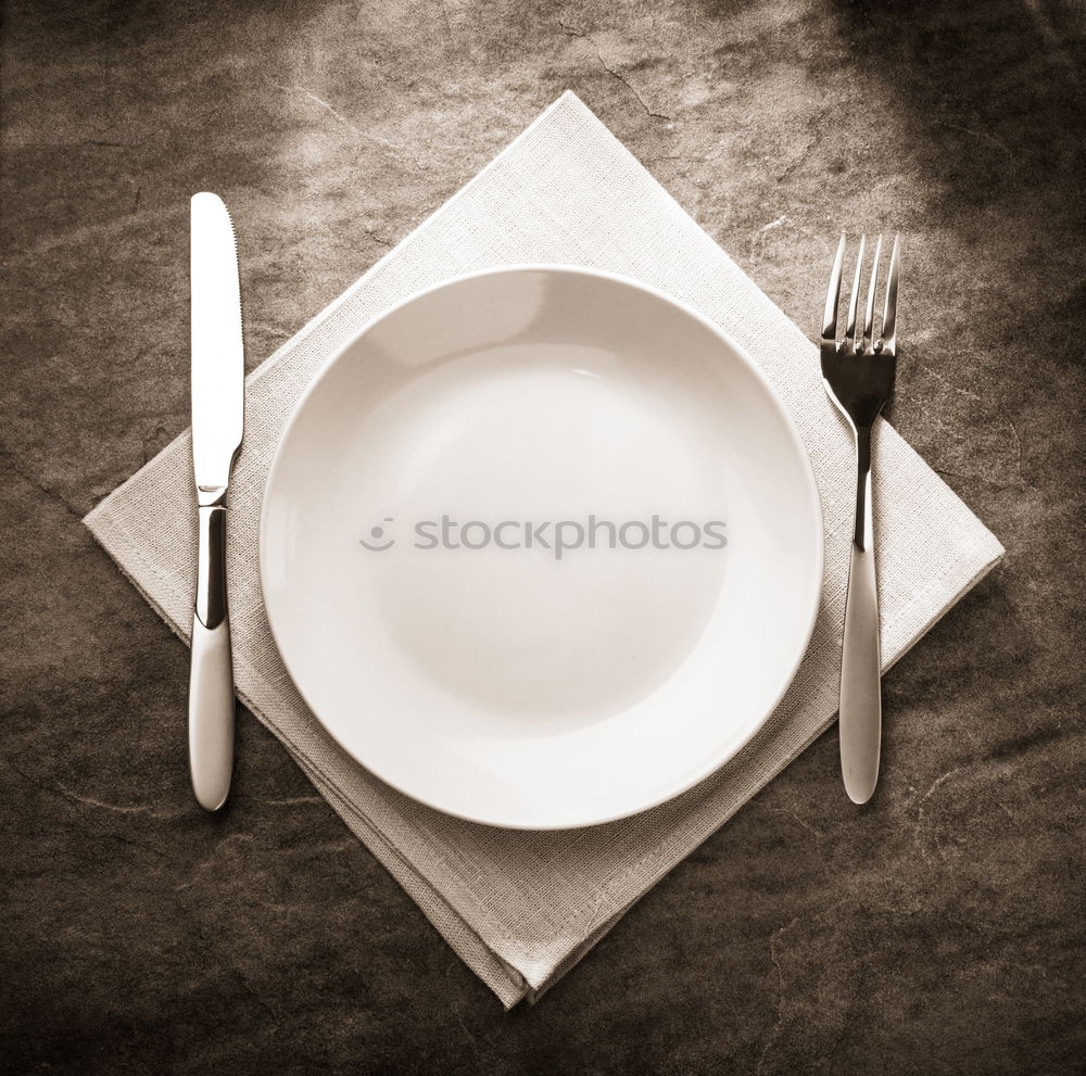 Similar – Half empty white plates, vintage knife and fork