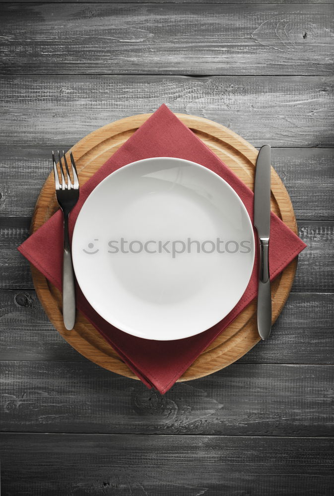 Similar – Spoon and fork on the plate framed with spices