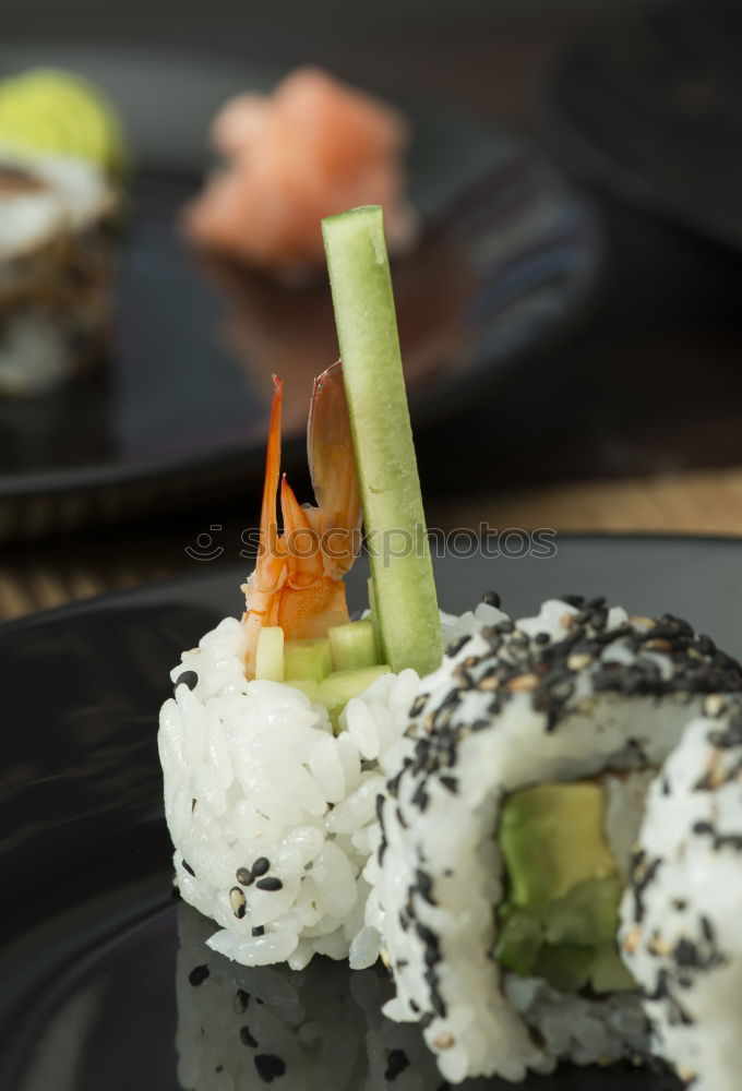 Similar – Female chef placing japanese sushi rolls on a tray