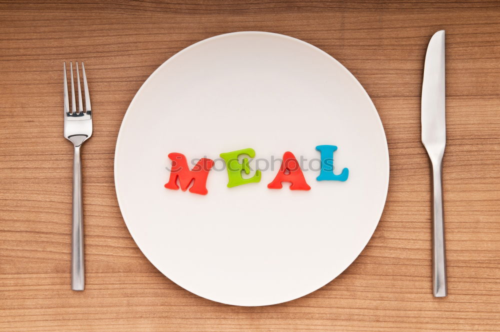 Similar – Image, Stock Photo The letters HUNGER on a plate with knife and fork and napkin and a glass of water