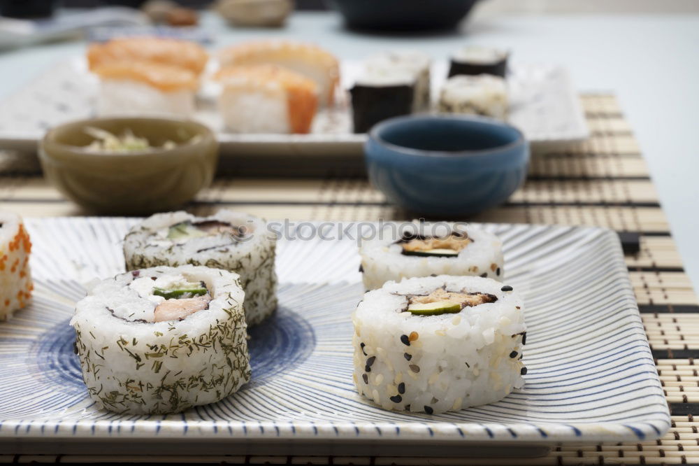 Similar – Female chef placing japanese sushi rolls on a tray