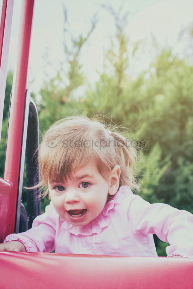 Similar – Young girl playing to driving a toy car