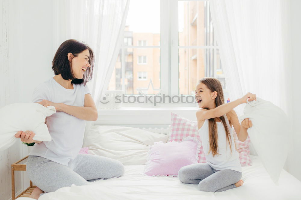 Similar – happy mother and child son playing pillow fight