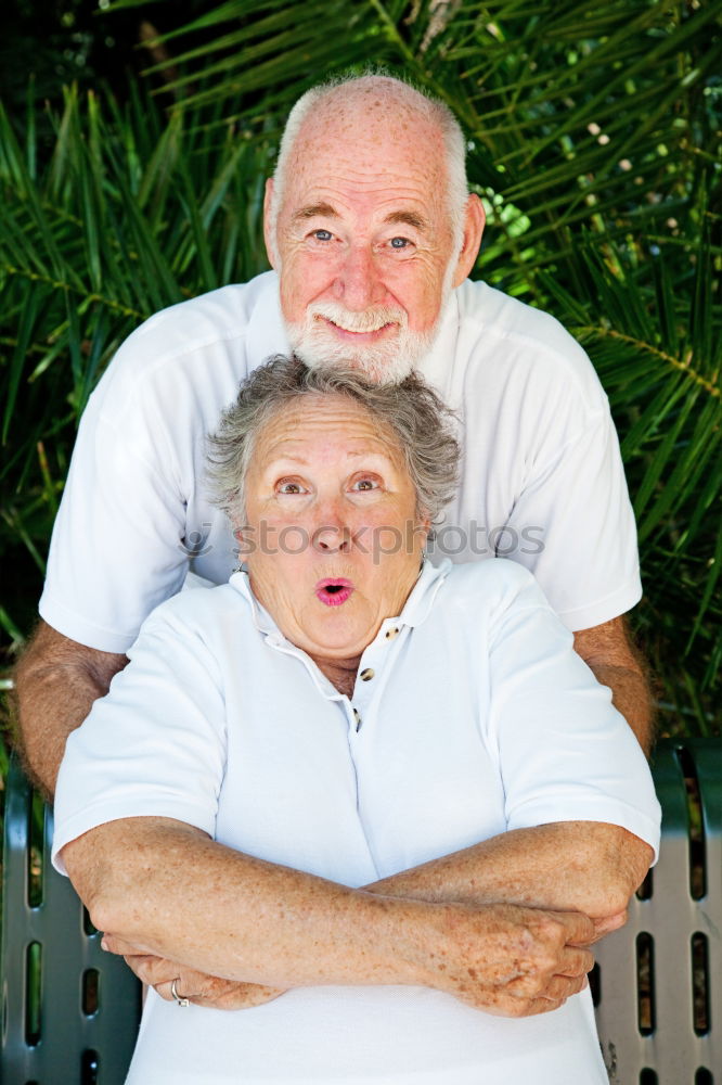 Similar – Smiling senior couple looks lovingly into each other’s eyes