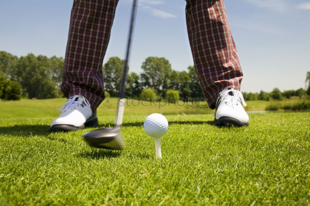 Similar – Golfer performs a golf shot from the fairway