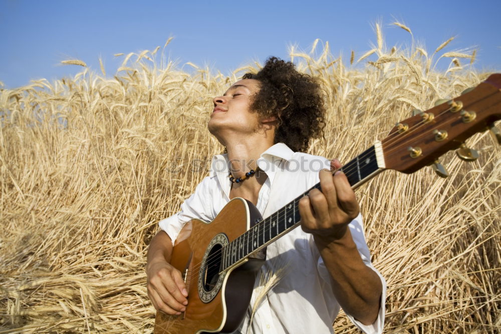 Similar – Image, Stock Photo Man with guitar on field